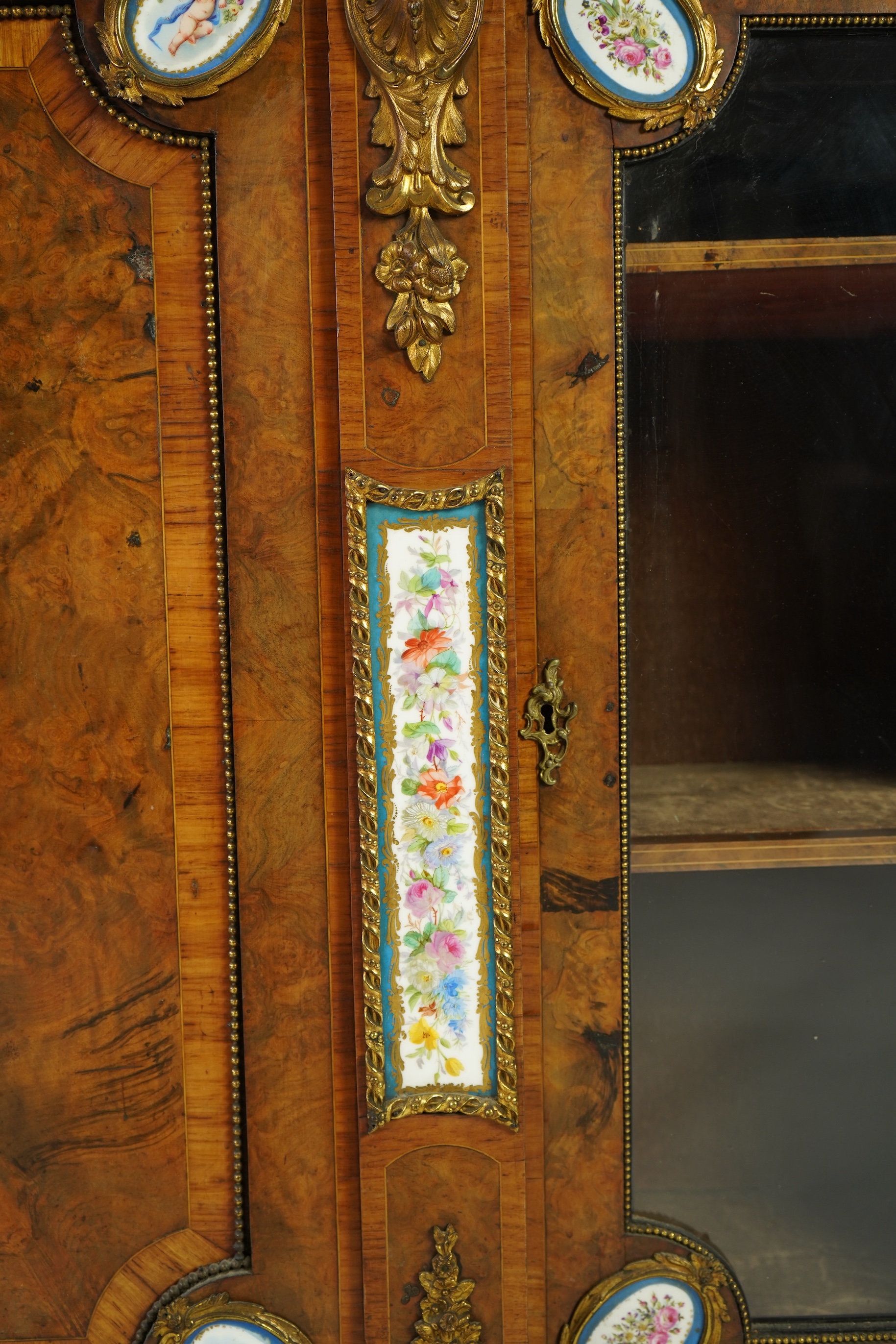 A Victorian tulip banded and gilt metal mounted walnut breakfront side cabinet